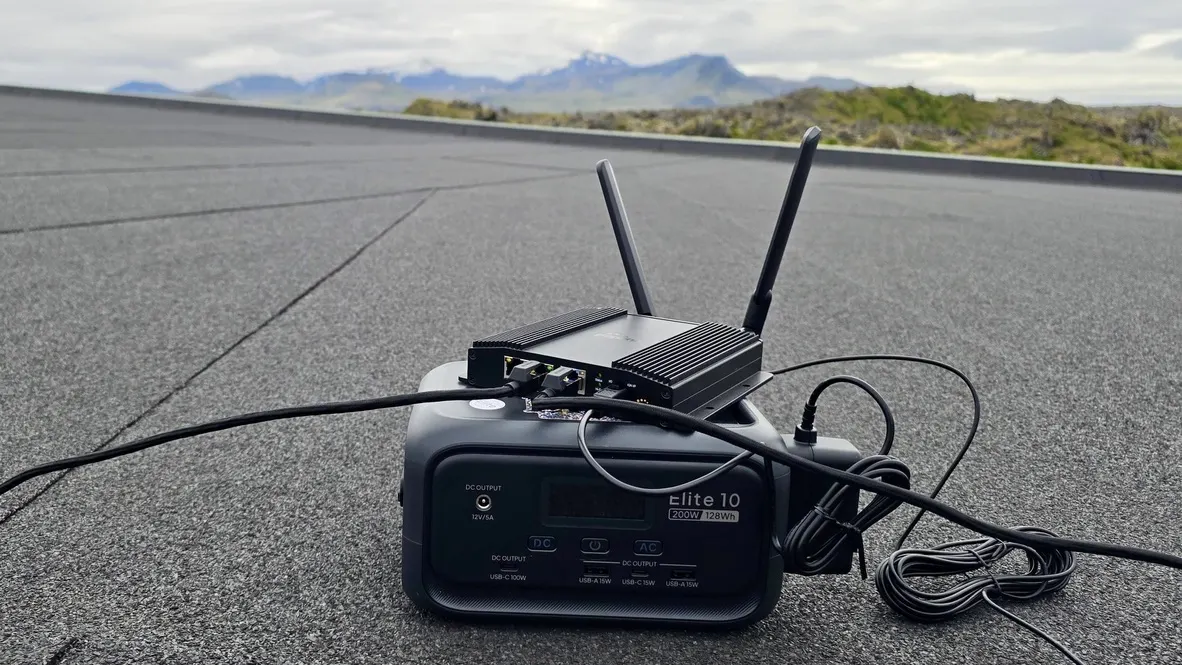The Peplink router and portable battery on the flat rooftop at Hellisandur, with the Snæfellsnes mountains behind.